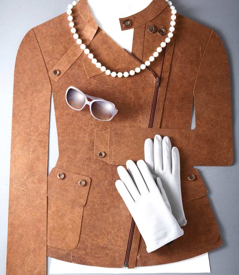 Paper art Mode mit Lederjacke aus Papier mit Sonnenbrille, Perlenkette und weißen Handschuhen.